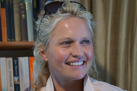 Lottie Phillips in her office by her bookcase